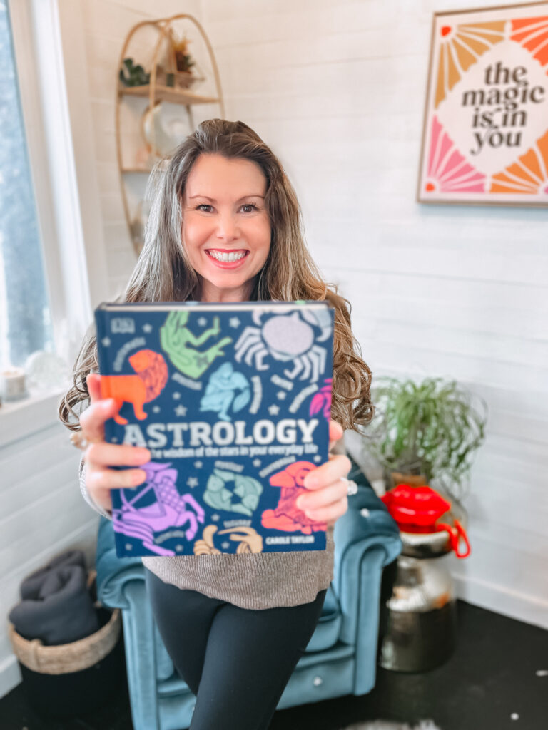 a picture of tara kinden with an astrology book
